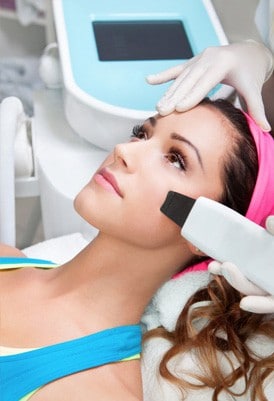 image of a woman getting sun spot removal treatment on her face