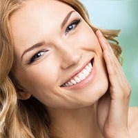 woman smiling after getting scar removal treatment